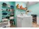Well-organized laundry room features ample shelving and a modern washer and dryer at 17380 Shirley Ave, Port Charlotte, FL 33948