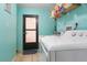 Bright laundry room with washer, dryer, and door to the exterior at 17380 Shirley Ave, Port Charlotte, FL 33948