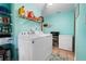 Functional laundry room with washer, dryer, shelving, and additional storage, efficiently designed at 17380 Shirley Ave, Port Charlotte, FL 33948