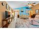 Bright living room featuring ceramic tile flooring, a ceiling fan, and neutral colors for a relaxing atmosphere at 17380 Shirley Ave, Port Charlotte, FL 33948