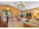 Open-concept living area with a dining table and chairs, ceiling fan, and views of the backyard and pool at 17380 Shirley Ave, Port Charlotte, FL 33948
