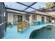 Seating area by a screened in pool with patio furniture at 17380 Shirley Ave, Port Charlotte, FL 33948