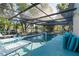 Sparkling enclosed pool with blue tiling and lounge seating at 17380 Shirley Ave, Port Charlotte, FL 33948