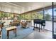 Comfortable screened in porch with an outdoor kitchen and seating at 17380 Shirley Ave, Port Charlotte, FL 33948