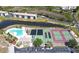 Aerial view of condo community with pool, tennis courts, and surrounding landscape at 175 Kings Hwy # 736, Punta Gorda, FL 33983
