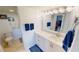 Modern bathroom with a white vanity, stylish lighting, and neutral-colored tile at 175 Kings Hwy # 736, Punta Gorda, FL 33983