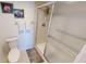 Well-lit bathroom featuring a step-in shower with glass doors and a tiled floor at 175 Kings Hwy # 736, Punta Gorda, FL 33983