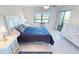Bright bedroom with tiled flooring, a ceiling fan, and an outdoor view at 175 Kings Hwy # 736, Punta Gorda, FL 33983