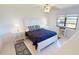 Cozy bedroom featuring a queen-sized bed, neutral walls, and a bright window at 175 Kings Hwy # 736, Punta Gorda, FL 33983
