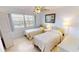 Comfortable bedroom with neutral tones, twin beds, and a ceiling fan at 175 Kings Hwy # 736, Punta Gorda, FL 33983