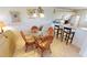 Bright dining area with a glass-top table and seating for four adjacent to the kitchen at 175 Kings Hwy # 736, Punta Gorda, FL 33983