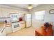 Kitchen showcasing white appliances, cabinets, adjacent breakfast table and bright natural light at 175 Kings Hwy # 736, Punta Gorda, FL 33983