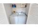 Bright laundry room with a newer washer and dryer, plus a shelf for storage at 175 Kings Hwy # 736, Punta Gorda, FL 33983