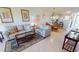 Spacious living area with tile floors and a view into the dining area and kitchen at 175 Kings Hwy # 736, Punta Gorda, FL 33983