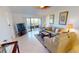 Inviting living room featuring neutral decor, tile flooring, and a sliding glass door to a private balcony at 175 Kings Hwy # 736, Punta Gorda, FL 33983