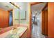 Bathroom featuring a vanity, mirror and access to hall at 179 Boundary Blvd # 4, Rotonda West, FL 33947