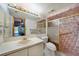 Bathroom with a shower and tub combo and a pink and white tiled walls at 179 Boundary Blvd # 4, Rotonda West, FL 33947
