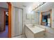 Well-lit bathroom featuring white cabinets, vanity, and framed mirror at 179 Boundary Blvd # 4, Rotonda West, FL 33947