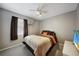 Comfortable bedroom featuring ceiling fan, large bed and neutral colored walls at 179 Boundary Blvd # 4, Rotonda West, FL 33947