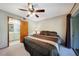 Comfortable bedroom featuring ceiling fan, large bed and exterior access at 179 Boundary Blvd # 4, Rotonda West, FL 33947