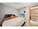 Comfortable bedroom featuring ceiling fan, television and an en suite bathroom at 179 Boundary Blvd # 4, Rotonda West, FL 33947