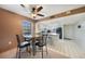 Dining room featuring a black table and chairs, ceiling fan and kitchen access at 179 Boundary Blvd # 4, Rotonda West, FL 33947