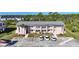 Exterior view of a pink two-story condo building with multiple parking spaces in front at 179 Boundary Blvd # 4, Rotonda West, FL 33947