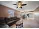 View of the living room and kitchen featuring carpet, ceiling fans and black kitchen appliances at 179 Boundary Blvd # 4, Rotonda West, FL 33947