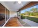 Enclosed porch with wood floors offering exterior views and interior access at 179 Boundary Blvd # 4, Rotonda West, FL 33947