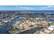 Expansive aerial view of a waterfront community featuring luxurious homes with canal access to the open sea at 1791 Belle Ct, Punta Gorda, FL 33950