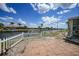 Home's backyard with brick patio and water views with canal at 1791 Belle Ct, Punta Gorda, FL 33950