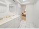 Bright bathroom featuring a double sink vanity with a view into the Primary bedroom at 1791 Belle Ct, Punta Gorda, FL 33950