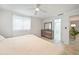 Bright bedroom features a ceiling fan, tiled floors and an ensuite bathroom at 1791 Belle Ct, Punta Gorda, FL 33950