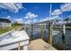 Waterfront home featuring a dock and boat lift for easy access to waterways, including a utility sink for convenience at 1791 Belle Ct, Punta Gorda, FL 33950