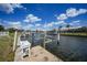 View of the dock along a canal featuring a sink, boat lift, and ladder at 1791 Belle Ct, Punta Gorda, FL 33950
