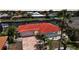Charming home featuring a red tile roof, a brick-paved driveway, and lush landscaping in a serene neighborhood at 1791 Belle Ct, Punta Gorda, FL 33950