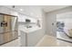 Modern kitchen featuring white cabinets, stainless steel appliances, and a breakfast bar for casual dining at 1791 Belle Ct, Punta Gorda, FL 33950