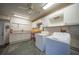 Well-equipped laundry room with modern washer and dryer, ample storage cabinets, and practical utility sink at 1791 Belle Ct, Punta Gorda, FL 33950