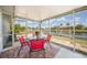 Screened patio overlooking a canal with a table, chairs, and brick flooring at 1791 Belle Ct, Punta Gorda, FL 33950