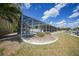 Spacious yard with screened pool, landscaping, and waterfront view at 1791 Belle Ct, Punta Gorda, FL 33950