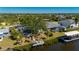 Waterfront home with dock, pool, and screened-in lanai amidst lush landscaping at 18417 Ohara Dr, Port Charlotte, FL 33948