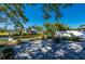 Beautiful outdoor area with mature tree and lush greenery, overlooking the water at 18417 Ohara Dr, Port Charlotte, FL 33948