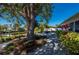 Beautiful backyard with mature trees, landscaped garden beds, and waterfront access at 18417 Ohara Dr, Port Charlotte, FL 33948