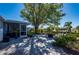 Charming outdoor area with a patio, mature tree providing shade, and waterfront views at 18417 Ohara Dr, Port Charlotte, FL 33948
