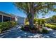 Beautiful backyard area with mature tree, lush landscaping, and a shed for extra storage at 18417 Ohara Dr, Port Charlotte, FL 33948