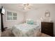 Comfortable bedroom with a ceiling fan, plantation shutters and a neutral color scheme at 18417 Ohara Dr, Port Charlotte, FL 33948