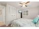 Bedroom featuring an ocean-themed comforter and flat-screen TV with plantation shutters at 18417 Ohara Dr, Port Charlotte, FL 33948
