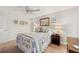 Bright bedroom with neutral walls and carpet and a large bed with an ocean-themed comforter at 18417 Ohara Dr, Port Charlotte, FL 33948