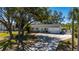 Charming single-story home with a well-manicured lawn, mature trees, and a long driveway, offering great curb appeal at 18417 Ohara Dr, Port Charlotte, FL 33948