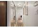 Hallway features tile flooring, neutral paint, and a mirrored closet that leads to the bedroom at 18417 Ohara Dr, Port Charlotte, FL 33948